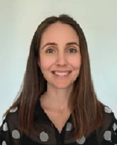 Dr. Tegan Durnan smiles at the camera. She has long dark hair