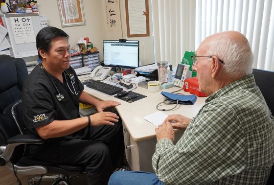 Doctor speaks to a patient in a doctor room.