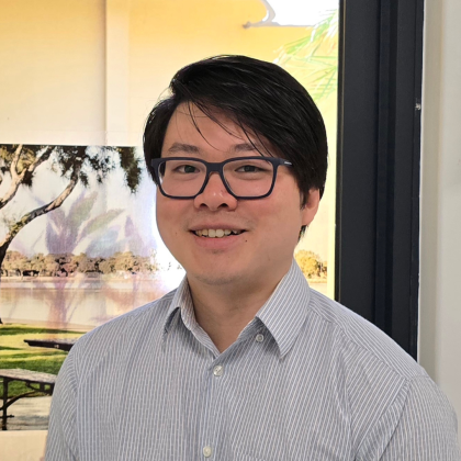 Dr Htet Oo smiles at the camera. He has short dark Hair and black glasses