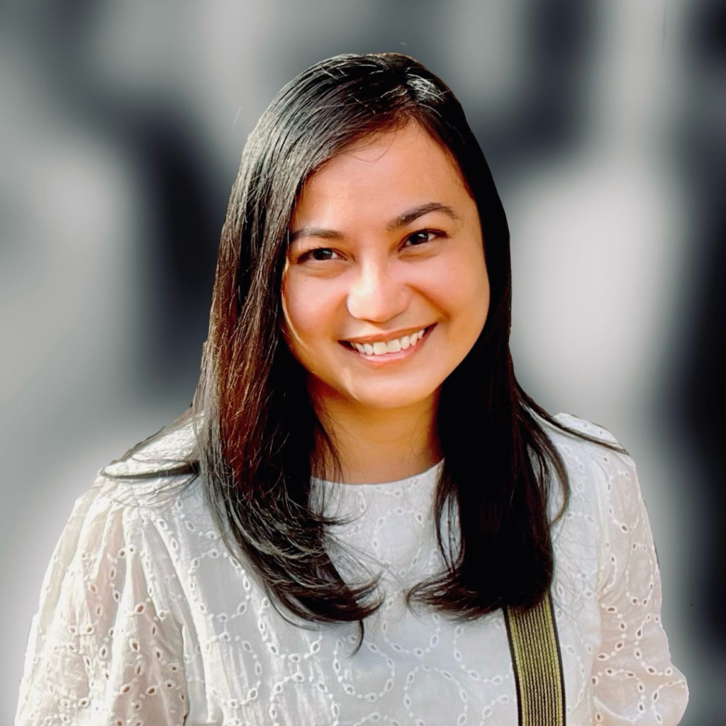 Dr Josephine Tiu smiles at the camera. She has medium dark hair